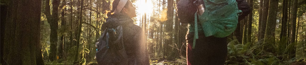 Two women hiking in a forest after a work day, an example of the Vancouver Lifestyle