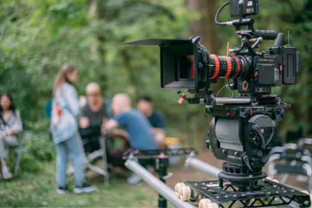The Winter 2022/23 Vancouver Economy Report features the Film and TV sector. Pictured: a film camera in an outdoor set with the film crew in the background
