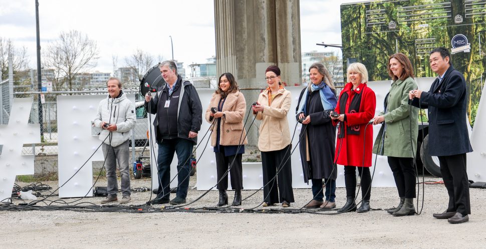 Business leaders from the film sector, plus City of Vancouver elected officials "flip the switch" to turn on the new clean energy kiosk in downtown Vancouver