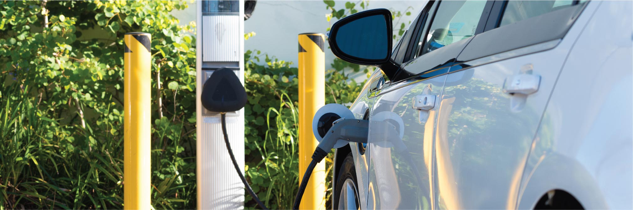 An electric car charger plugged into an electric vehicle