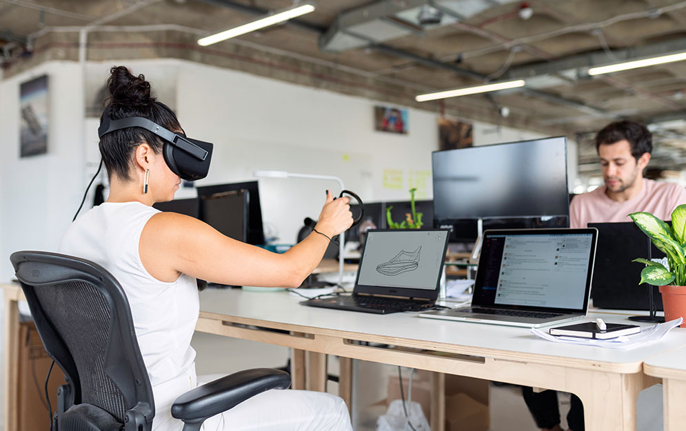 Photo: A woman wearing a VR headset in an office, reflecting a thriving technology ecosystem in Vancouver